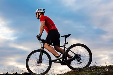 Image showing Man in helmet and glasses stay on the bicycle