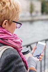 Image showing Woman using smartphone at river