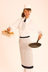 Image showing female chef with chanterelle mushrooms, pan and apron