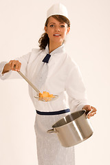 Image showing female chef with cooking pot