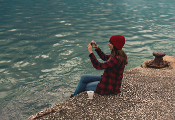 Image showing Woman taking pictures with a cellphone