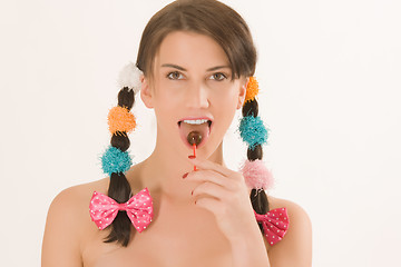 Image showing Girl with braids and colorful lollipops