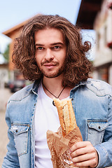 Image showing Happy with a fresh baguette in the morning