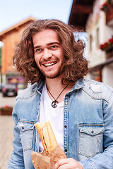 Image showing Happy with a fresh baguette in the morning