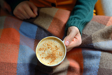 Image showing Woman holding hot cup of cappuccino