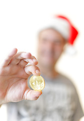 Image showing Man holding a Bitcoin BTC in his hand