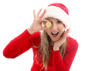 Image showing Woman h olding a Bitcoin to eyeball and surprised face