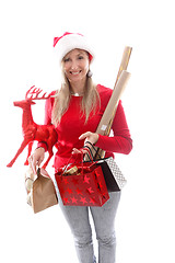 Image showing A woman carrying various gifts and decorations for Christmas