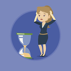 Image showing Desperate business woman looking at hourglass.