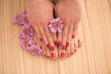 Image showing female feet and hands at spa salon