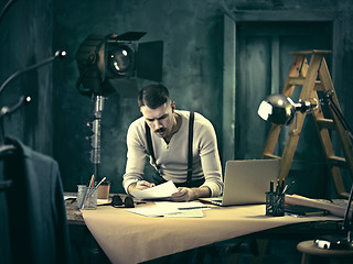 Image showing Architect working on drawing table in office