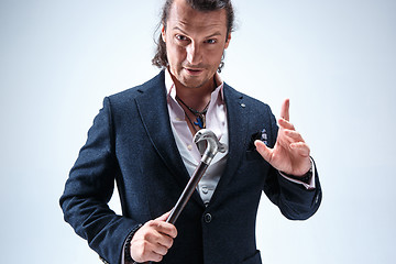 Image showing The mature barded man in a suit holding cane.