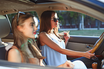 Image showing young women in the car smiling