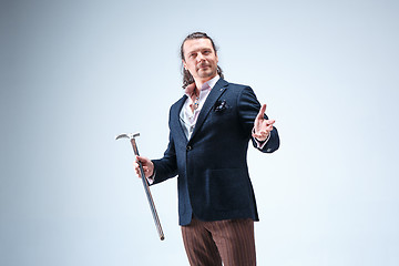 Image showing The mature barded man in a suit holding cane.