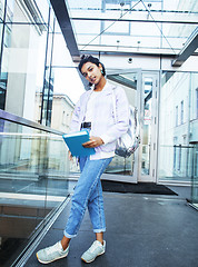 Image showing young cute indian girl at university building sitting on stairs 