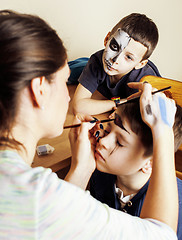 Image showing little cute child making facepaint on birthday party, zombie Apocalypse facepainting, halloween preparing concept, lifestyle people babes