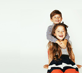 Image showing little cute boy and girl hugging playing on white background, ha