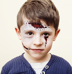 Image showing little cute child making facepaint on birthday party, zombie Apo