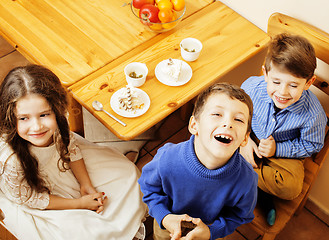 Image showing little cute boys eating dessert on wooden kitchen. home interior. smiling adorable friendship together forever friends, lifestyle people concept 