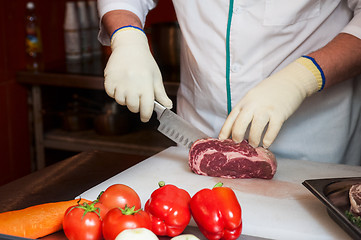 Image showing Chef cutting meat