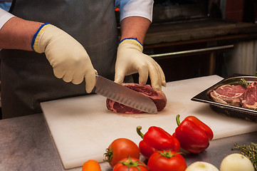 Image showing Chef cutting meat