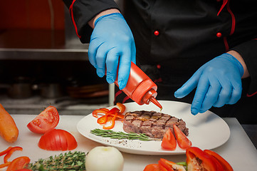 Image showing Chef set grilled meat