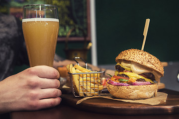 Image showing Man eating burgers