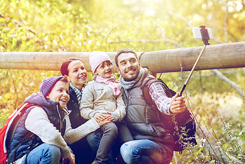 Image showing happy family with smartphone selfie stick in woods