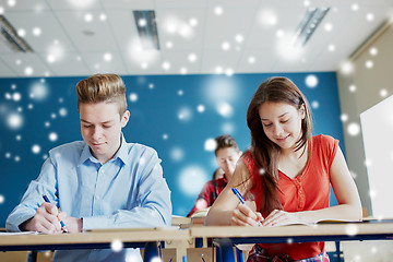 Image showing group of students with books writing school test