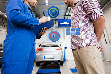 Image showing auto mechanic with clipboard and man at car shop