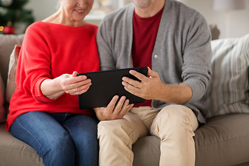 Image showing senior couple with tablet pc at christmas