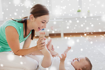 Image showing happy mother playing with little baby at home