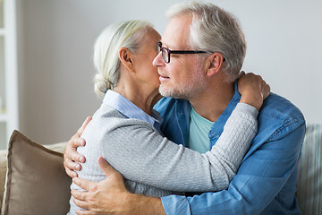 Image showing happy senior couple hugging at home