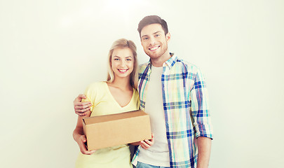 Image showing smiling couple with box moving to new home