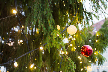 Image showing close up of fir with christmas tree toys outdoors