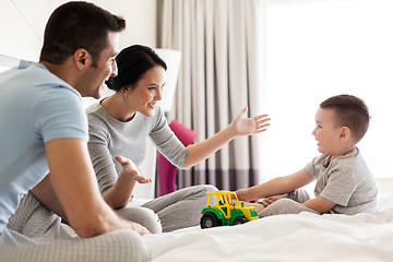 Image showing happy family in bed at home or hotel room