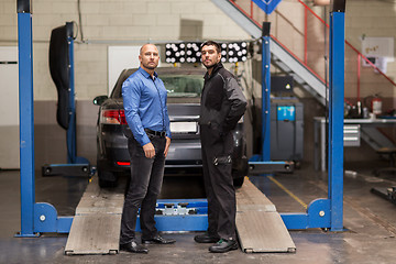 Image showing auto mechanic and customer at car shop