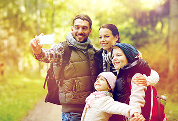 Image showing family with backpacks taking selfie by smartphone