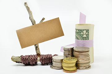 Image showing Paper sign board with stack of coins