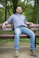 Image showing handsome bearded man sitting outdoors