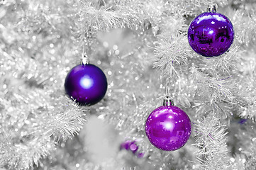 Image showing Trendy colored violet or ultraviolet baubles on silver artificial christmas tree