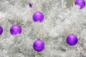 Image showing Trendy colored ultraviolet baubles on silver artificial christmas tree