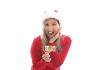 Image showing Surprised woman holding a bitcoin and a paper wallet