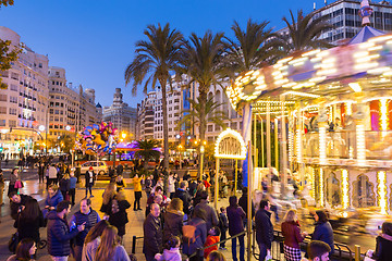 Image showing Christmas fair with carousel on Modernisme Plaza of the City Hall of Valencia, Spain.