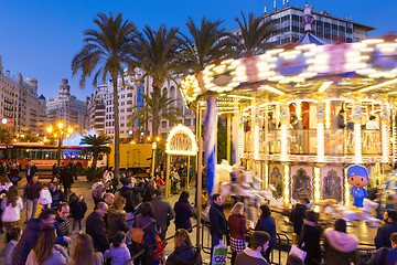 Image showing Christmas fair with carousel on Modernisme Plaza of the City Hall of Valencia, Spain.