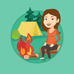 Image showing Woman sitting on log near campfire in the camping.