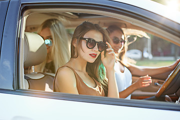 Image showing young women in the car smiling