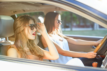 Image showing young women in the car smiling