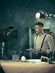 Image showing Architect working on drawing table in office