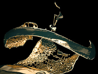 Image showing Liquid gold or oil splashes isolated on black